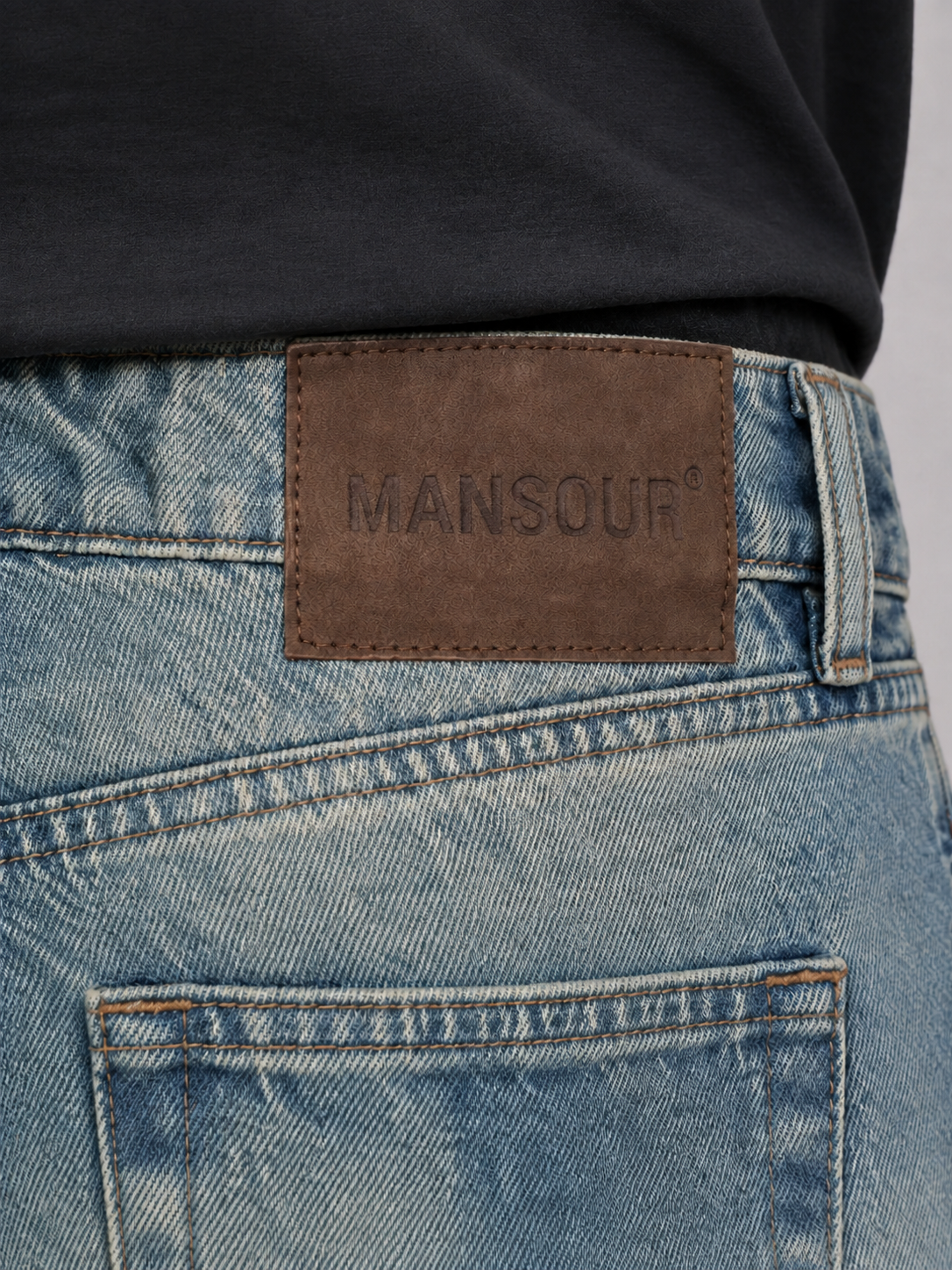 Detail of the Mansour Vintage Brown Washed Regular Fit Jeans showing the washed denim texture and distressed finish
