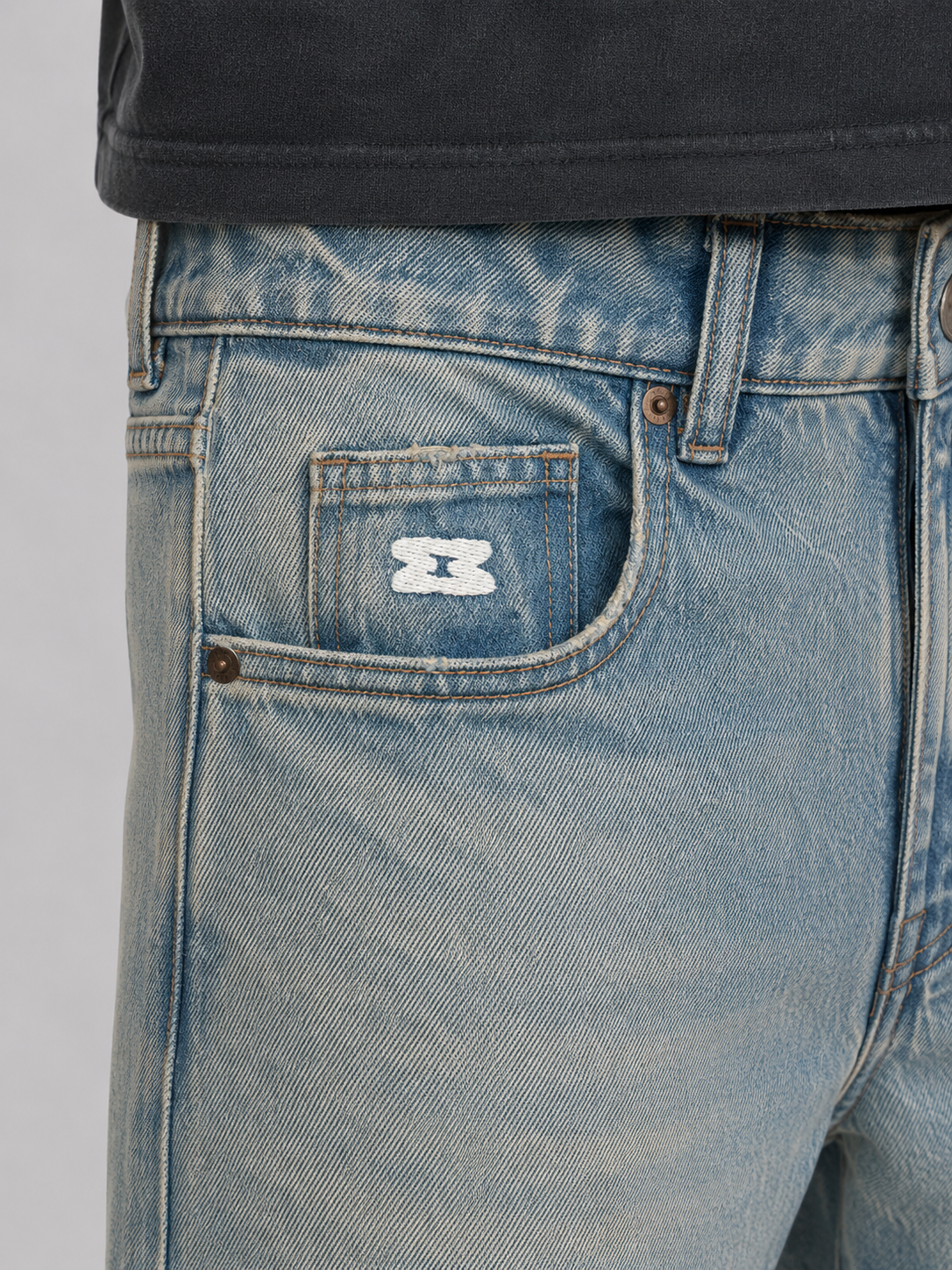 Mansour Hourglass logo embroidery on the coin pocket of the Vintage Brown Washed Regular Fit Jeans
